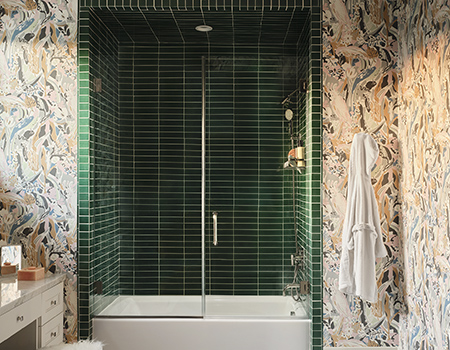 Custom bathroom with green shower tile and colorful modern abstract wallpaper in Houston, TX